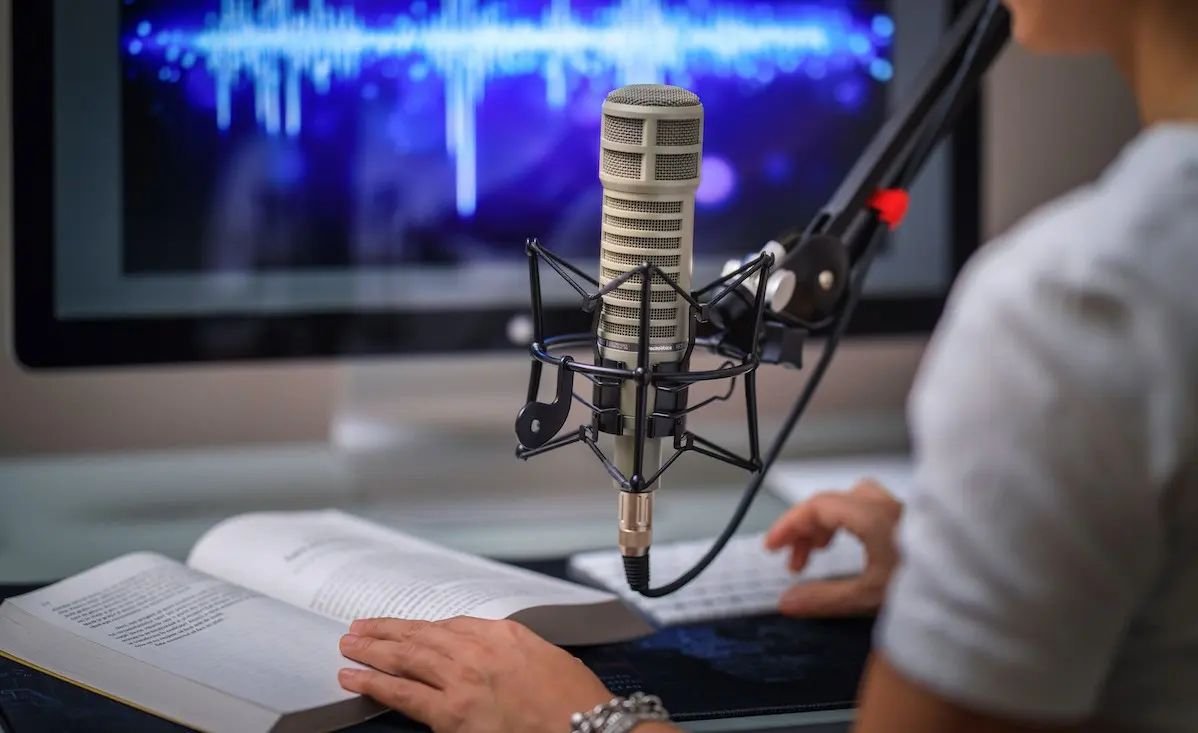 Audiobook narrator recording in a studio